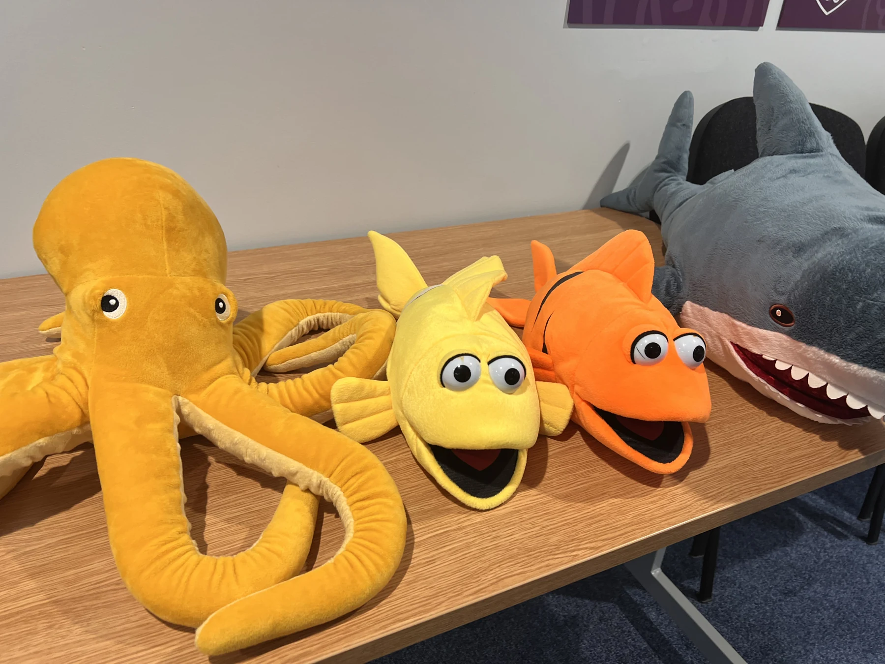 The Caught in the Net puppets together: a yellow octopus, yellow fish, orange Bobby and grey Sharky on a table